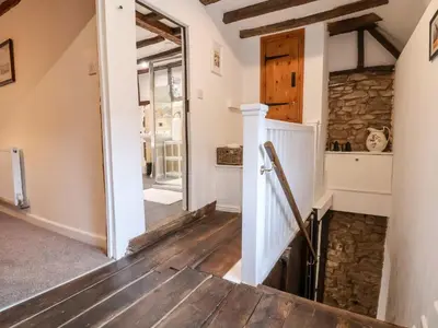 a staircase in a house with a stone wall at The Brewhouse in Church Stretton