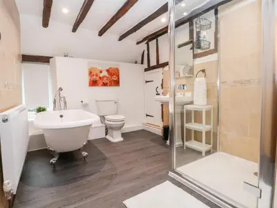 a bathroom with a tub and a toilet and a sink at The Brewhouse in Church Stretton