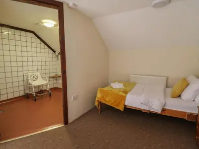 a bedroom with a bed and a table in a room at Y Felin in Llanybydder