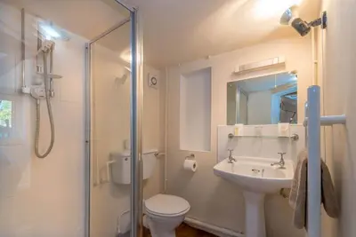 a bathroom with a toilet and a sink and a shower at Ty-Gwair-Byrdir in Dyffryn