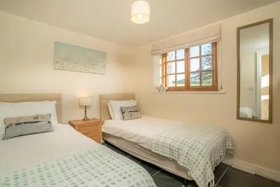 a bedroom with two beds and a window at Nant in Dyffryn