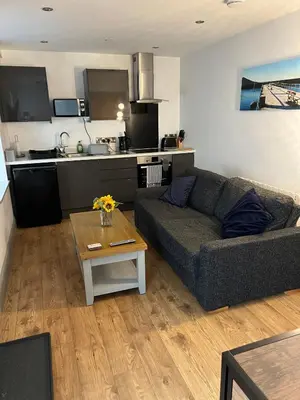 a living room with a couch and a table at Aberystwyth maisonette flat in Aberystwyth