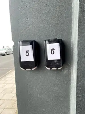 two clocks on a wall with the number six at Aberystwyth maisonette flat in Aberystwyth