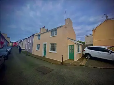 a white car parked in front of a house at Cosy Cottage in Aberaeron