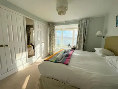 a bedroom with a large white bed with a window at 2 Bed in Aberdovey DY017 in Aberdyfi