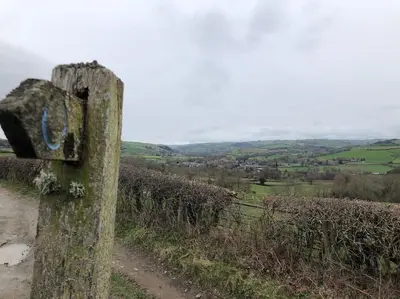 a sign on the side of a dirt road at Lavender Cottage, 3 School Road, Clun, Shropshire in Clun