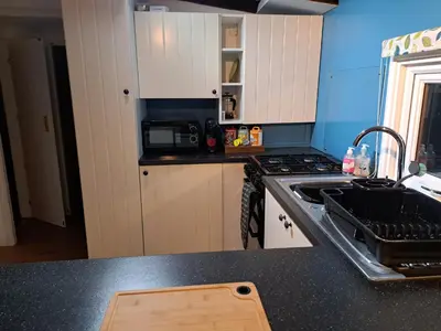 a kitchen with a sink and a stove at Bunny Lodge 30 - Riverside in Builth Wells