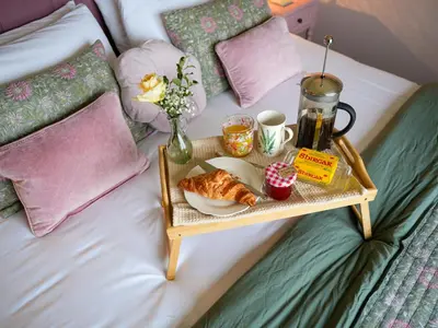 a tray of croissants and cupcakes on a bed at Dol Blodau in Llandrindod Wells
