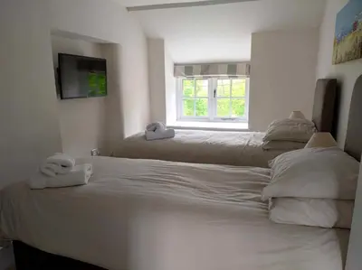 a bedroom with two beds with towels on them at Afonfa - Llanuwchllyn in Bala