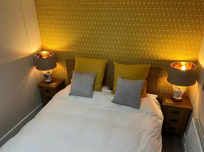 a bedroom with a white bed with two lamps on it at The Cherries - Caer beris holiday park 2 bedroom lodge - No commercial vehicles allowed on site in Builth Wells