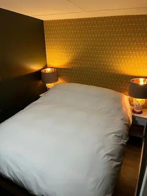 a bedroom with a white bed and two lamps at The Cherries - Caer beris holiday park 2 bedroom lodge - No commercial vehicles allowed on site in Builth Wells