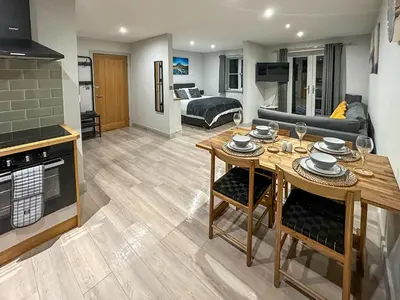 a living room with a table and a couch at The Annexe in Guilsfield
