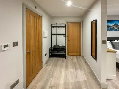 a hallway with a door leading to a bedroom at The Annexe in Guilsfield