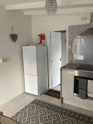 a kitchen with a white refrigerator and a stove at 7F Cwtch Cymru Lodge, Caer Beris Holiday Park - no commercial vehicles permitted on site in Builth Wells