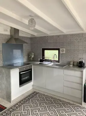 a kitchen with white cabinets and a sink at 7F Cwtch Cymru Lodge, Caer Beris Holiday Park - no commercial vehicles permitted on site in Builth Wells