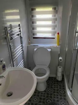 a small bathroom with a toilet and a sink at 7F Cwtch Cymru Lodge, Caer Beris Holiday Park - no commercial vehicles permitted on site in Builth Wells