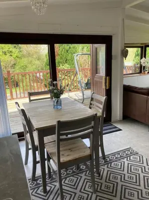a wooden table and chairs in a living room at 7F Cwtch Cymru Lodge, Caer Beris Holiday Park - no commercial vehicles permitted on site in Builth Wells