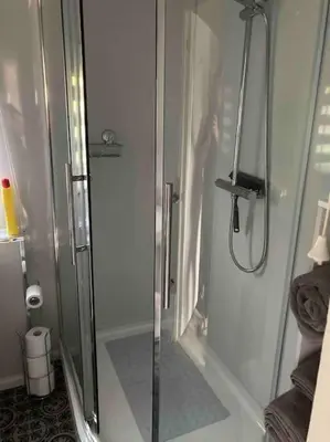 a person standing in a shower in a bathroom at 7F Cwtch Cymru Lodge, Caer Beris Holiday Park - no commercial vehicles permitted on site in Builth Wells