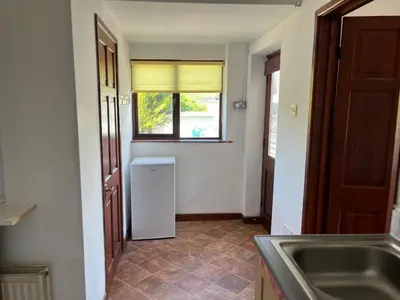 a kitchen with a sink and a window and a refrigerator at King room - PenrhynCoch - Aberystwyth in Aberystwyth