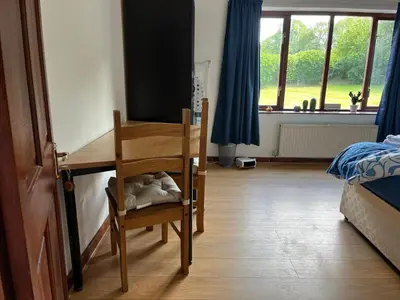 a bedroom with a desk and a wooden chair at King room - PenrhynCoch - Aberystwyth in Aberystwyth