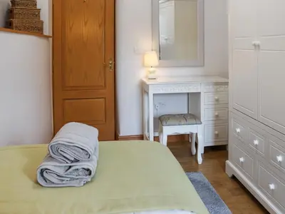 a bedroom with a bed and a vanity and a mirror at Glanllyn Lodge in Llanuwchllyn