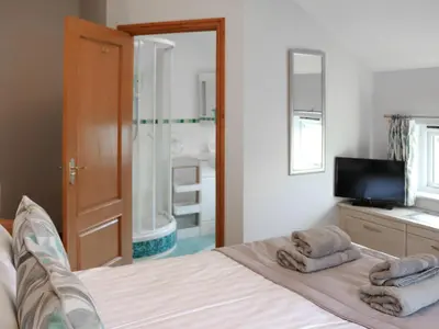 a bedroom with a bed with towels on it at Glanllyn Lodge in Llanuwchllyn