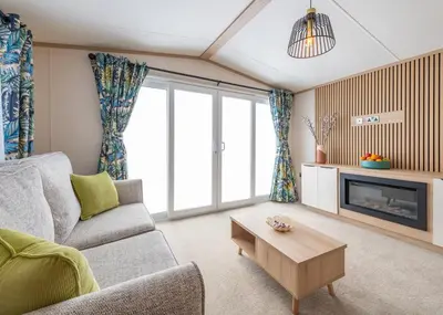 a living room with a couch and a tv at Aber Bay Holiday Park in Aberystwyth
