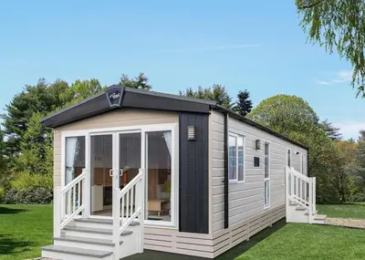 a small caravan with a black and white exterior at Aber Bay Holiday Park in Aberystwyth