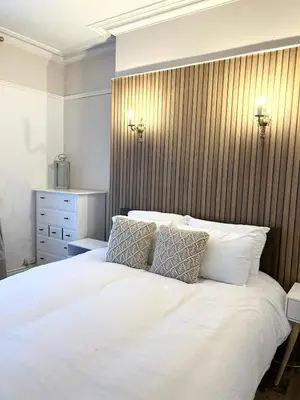a bedroom with a large white bed with two pillows at Mountain View Home - Dolgellau in Dolgellau