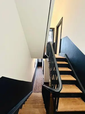 a staircase in a building with a black and white wall at Mountain View Home - Dolgellau in Dolgellau