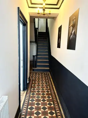 a hallway with a checkered floor and stairs at Mountain View Home - Dolgellau in Dolgellau