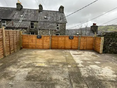 a wooden fence in front of a house at Mountain View Home - Dolgellau in Dolgellau