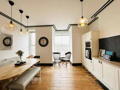 a kitchen with a table and a dining room at Mountain View Home - Dolgellau in Dolgellau