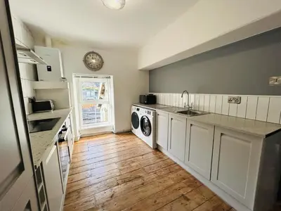 a kitchen with a sink and a washing machine at Dolgellau Grand Heights Apt in Dolgellau