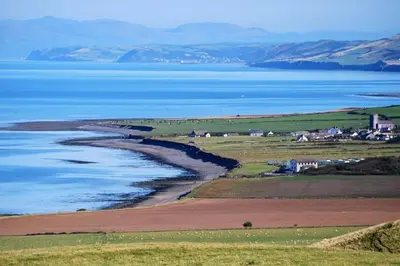 an aerial view of the ocean and a town at Tan Y Bryn in Llanrhystyd