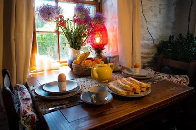 a table with bread and eggs and fruit on it at Tan Y Bryn in Llanrhystyd