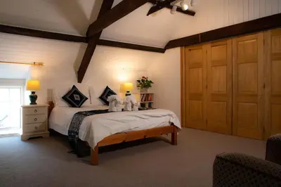 a bedroom with a bed with two stuffed animals on it at Yr Hen Efail - Old Smithy in Tregaron
