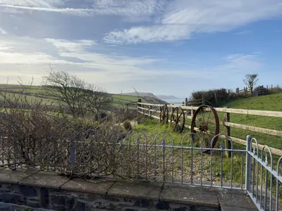 a fence with a gate in front of a field at Crogal Stable in New Quay