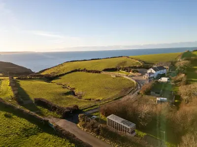 an aerial view of a farm and the ocean at Sea the Stars in New Quay