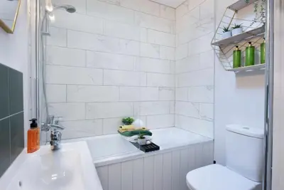 a bathroom with a tub and a sink and a toilet at The Hive, Central Ludlow, Free Parking, Boutique Hotel Style in Ludlow