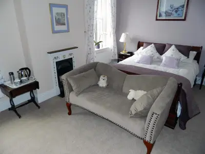 a living room with a couch and a bed at Penralley House B&B in Rhayader