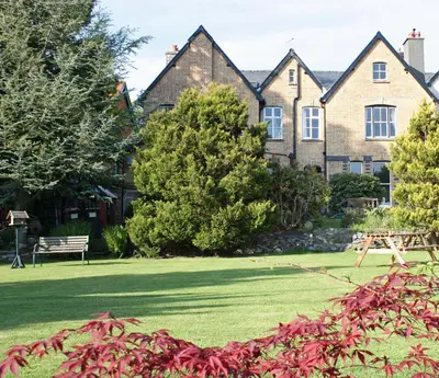 a house with a park in front of it at Penralley House B&B in Rhayader