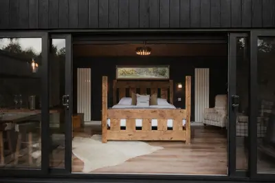 a bedroom with a bed inside of a house at 3 x bespoke built cabins with hot tubs, mid Wales in Newtown