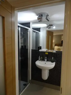 a bathroom with a sink and a shower at Ty Ni Holiday Apartment Aberdovey in Aberdyfi