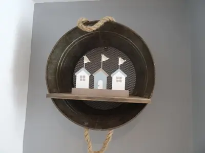 a wooden house ornament on a shelf on a wall at Ty Ni Holiday Apartment Aberdovey in Aberdyfi
