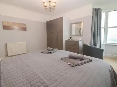 a bedroom with a bed with two towels on it at Morolwg in Barmouth