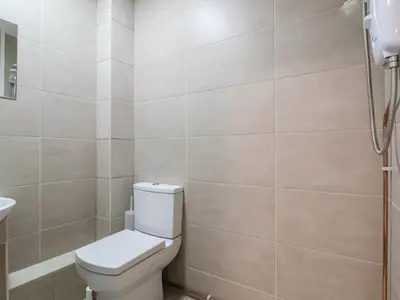 a bathroom with a toilet and a sink at The Duckhouse in Shrewsbury