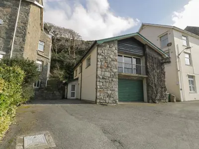 a house with a garage and a building at Borthwen in Barmouth