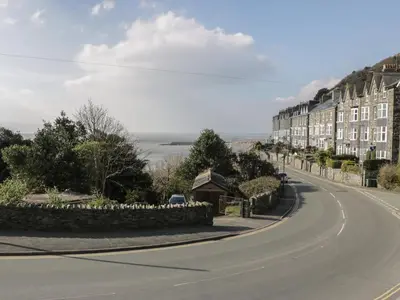 an empty street with buildings on the side of a road at Borthwen in Barmouth