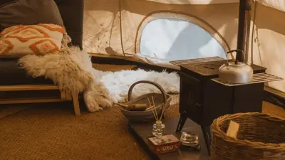 a room with a tent and a dog laying on the floor at Cuddfan Bach (The Little Hideaway) at Camp Plas in Welshpool